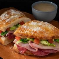 Italian Deli Boat · Calzone style sandwich baked with pizza dough stuffed with ham, salami, provolone, lettuce &...