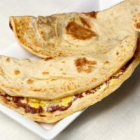 Baleada Sencilla · Flour tortilla, folded in half-filled with mashed fried beans, cheese, and cream.
