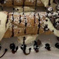 Cannoli · Cannoli shells filled with vanilla, rum, cream, and ricotta cheeses.