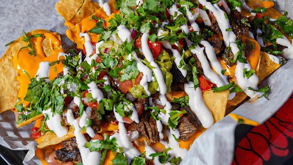 Loaded Nachos · Cheese sauce, refried beans, protein, pico de gallo, crema, guacamole. Chicken, birria or steak.