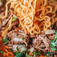 Birria Ramen · Birria beef, ramen noodles, consommé, onions, cilantro.