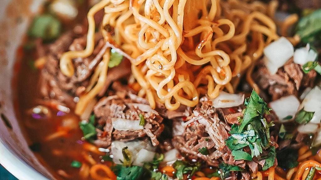 Birria Ramen · Birria beef, ramen noodles, consommé, onions, cilantro.