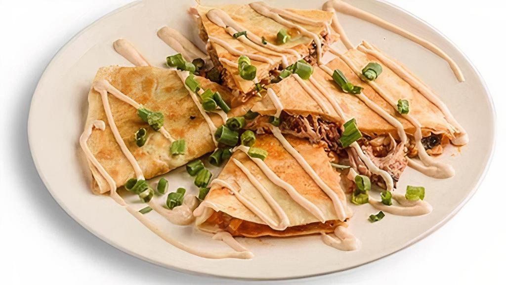 Smokehouse Quesadilla · Filled with cheese, charred red onions, Wickles Pickles, Dreamland BBQ Sauce, & stuffed with your choice of boneless rib tips, pork, chicken, or sausage. Topped with Alabama Twang Sauce & green onions.