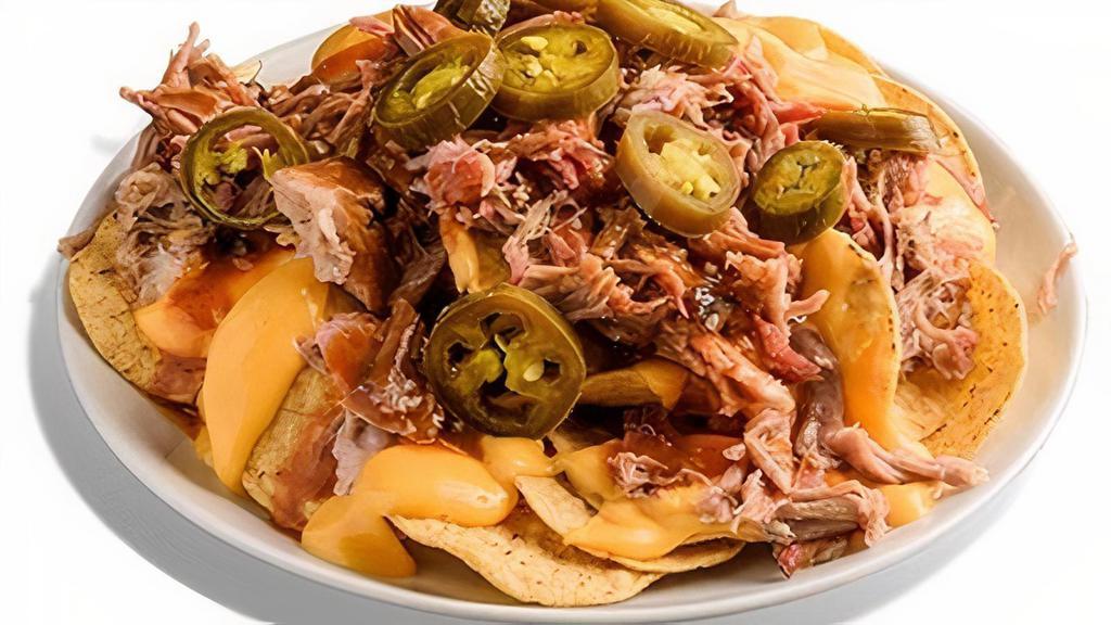 Stadium Nachos · A game day staple! Tortilla chips covered with nacho cheese, Dreamland BBQ Sauce, & jalapeños. Topped with your choice of boneless rib tips, pork, chicken, or sausage.