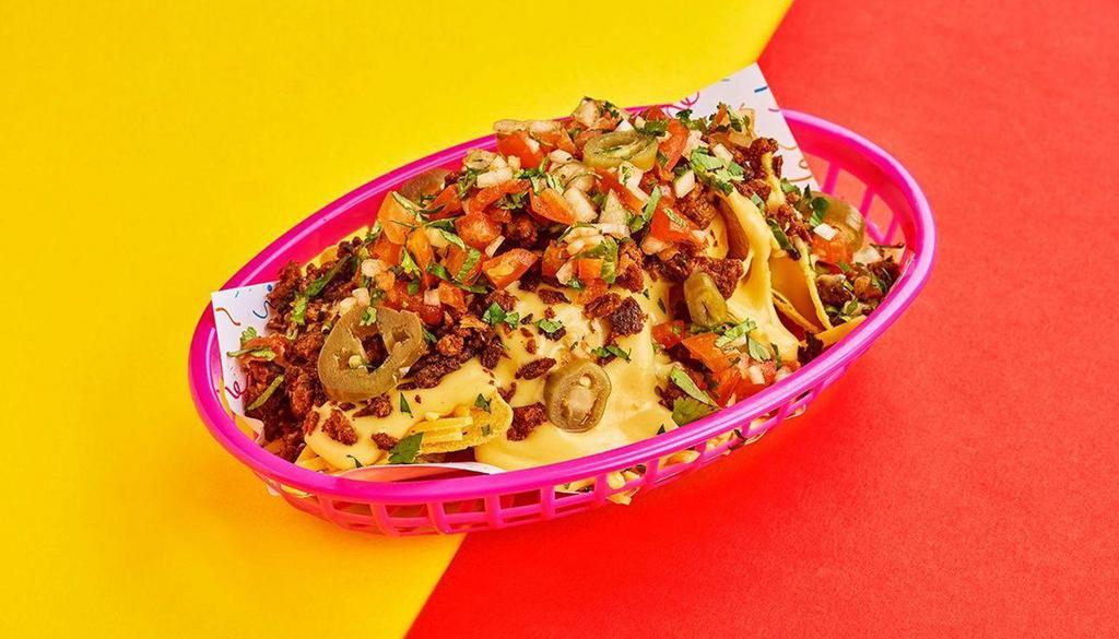 Beyond Meat Loaded Nachos · Crispy corn tortilla chips with plant-based Beyond Meat, queso, pickled jalapeno, cilantro, and your choice of sauce.