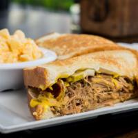 El Cubano Sandwich · Grilled ham, chipotle-braised pork, house-made pickles, provolone, and mustard, grilled on w...