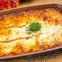 Lasgna · family size lasgna, with bechamel sauce and garlic bread. makes 12 servings.