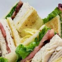 Turkey Club · Fresh roasted turkey, lettuce, tomatoes, bacon, Swiss cheese on 3 slices of white bread.