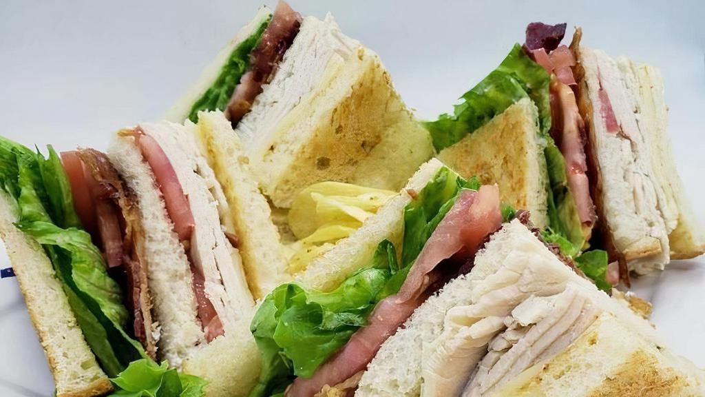 Turkey Club · Fresh roasted turkey, lettuce, tomatoes, bacon, Swiss cheese on 3 slices of white bread.
