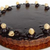 Chocolate Hazelnut Brulee Tart · Chocolate crust filled with caramel, hazelnut creme brulee, topped with chocolate ganache.
