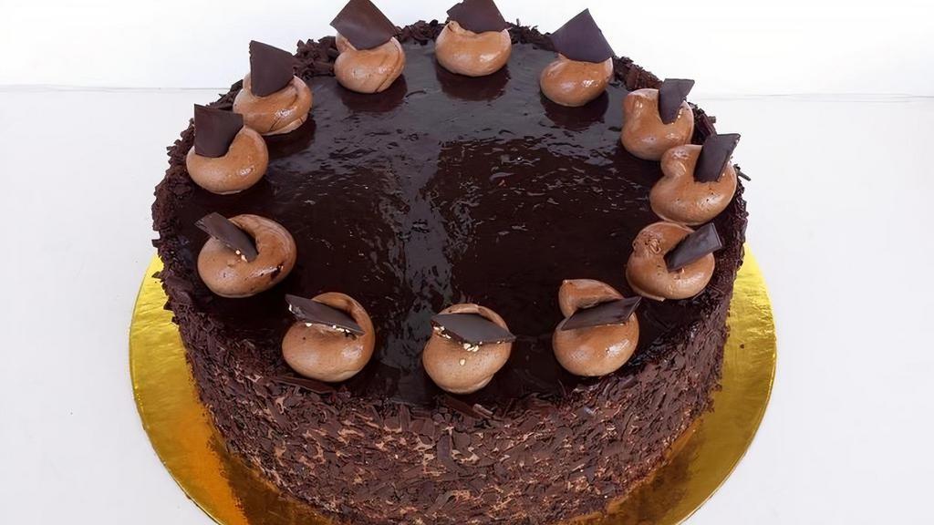 Chocolate Mousse Cake · 3 layer of moist chocolate cake, filled with dark chocolate mousse and cover with dark chocolate shavings and ganache.
