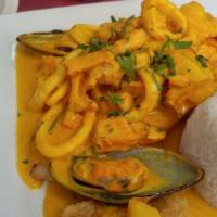 Pescado A Lo Macho · A fillet of fried fish topped with calamari, octopus and mussels in a fish sauce.