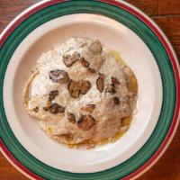Ravioli Al Tartufo · 5 big ravioli stuffed with truffles paste and mushroom in a truffle sauce and topped with fr...