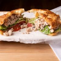 Chicken Salad Sandwich · Cut up chicken salad, Provolone, lettuce, and fresh tomatoes on a butter croissant.