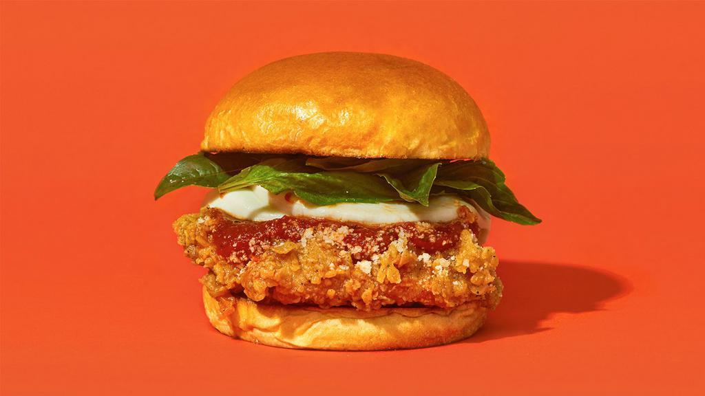 Parmigano · Our signature fried chicken served on a toasted bun and topped with marinara sauce, melted mozzarella cheese, and basil.