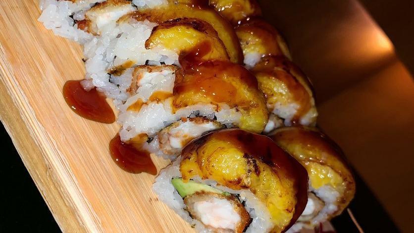 Tropical Roll · Shrimp tempura, wakame, and cream cheese topped with sweet plantains.