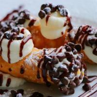 Mini Cannolis · 2 Crisp pastry shells filled with sweetened imported cheese dipped in chocolate chips and du...