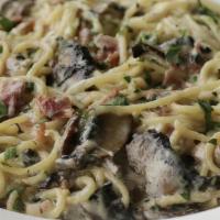 Pasta Carbonara · Prosciutto italian ham, portabella mushrooms, and fresh garlic simmered in alfredo and tosse...
