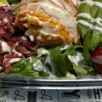 Cau Cobb · Bursting with so many flavors- our mixed greens are topped with grilled chicken, avocado, eg...