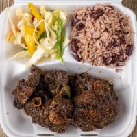 Oxtails · Served with plantain, cabbage or rice and peas.