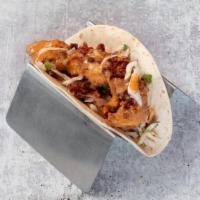 Fried Chicken Taco · buttermilk fried chicken, bacon cilantro slaw, ancho  lime sauce