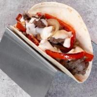 Steak & Cheese Philly Taco · grilled steak, queso blanco, grilled peppers and onions