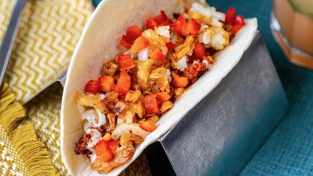 Low Country Boil Taco · grilled shrimp, chorizo, grilled onions, roasted corn, tater tots, spicy ranch, diced red peppers