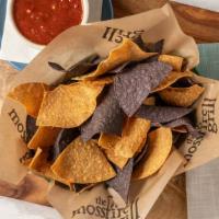 Chips & Salsa · Fire roasted tomato salsa, made fresh daily. Served with Blue and yellow corn chips.