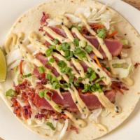 Pacific Rim Tuna Taco · Togarashi seared yellowfin tuna served on a soft flour tortilla with tangy Asian slaw, green...