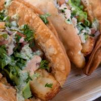 Empanada Tacos · 2 crispy empanadas stuffed with your choice of Beef or Chicken, then topped with fried chees...