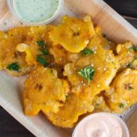 Tostones · Freshly cut Deep-fried plantains.
