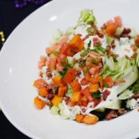 Bleu Cheese Wedge Salad · Crumbled bleu cheese, bacon, tomatoes, cucumbers and chives with bleu cheese dressing.