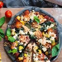 Black Pizza · Charcoal pesto, spinach, roasted tomato, mozzarella.