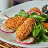 Salmon Bites · 4 Pieces of gourmet spiced salmon croquettes. Served with sweet dipping sauce.