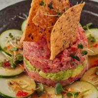 Tuna Tartar · Fine tuna chopped mixed with masago, scallions and house spicy sauce and a layer of creamy a...