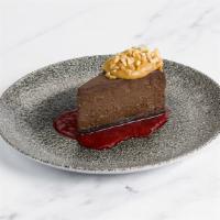 Peanut Butter + Chocolate Cheesecake · Peanut butter mousse, raspberry coulis, crushed peanuts.