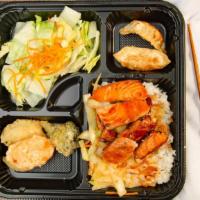Hibachi Salmon Bento Box · Served with house salad 2 pieces dumpling and 3 pieces vegetable tempura. comes with a choic...