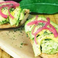 Avocado Toast · Two pieces of our delicious bread with avocado spread mixed with red onions, chia seeds and ...