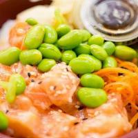 Spicy Salmon Poke Bowl · Spicy salmon, edamame, carrot, ginger, and sesame seeds. Served on a bed of sushi rice.