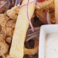 Chicharron De Calamar · Contains gluten. Crispy calamari rings served with fried cassava, tartar sauce, and criolla ...
