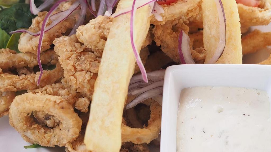 Chicharron De Calamar · Contains gluten. Crispy calamari rings served with fried cassava, tartar sauce, and criolla salad.