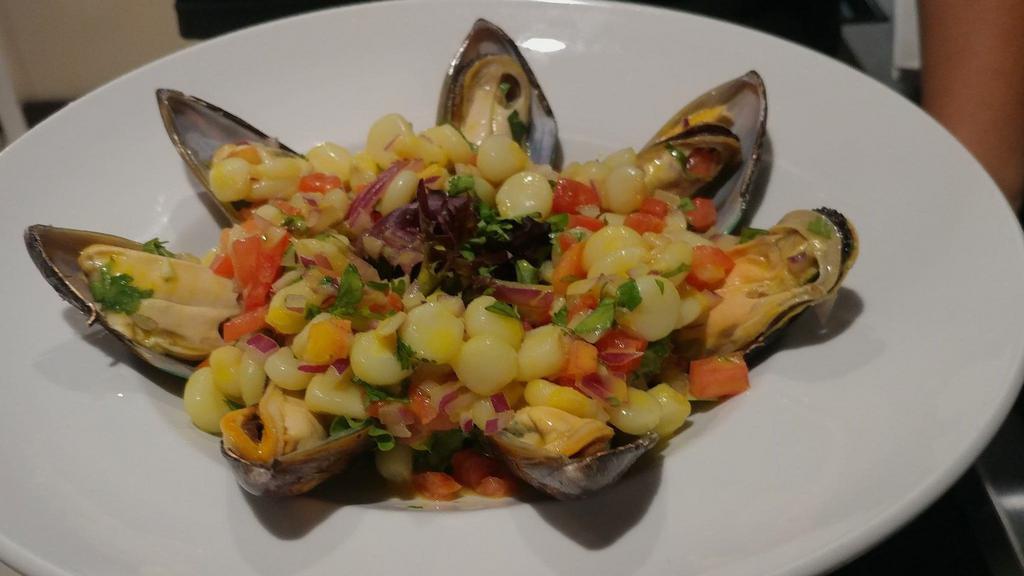 Mussels Chalaca Style / Choros A La Chalaca · Mussels marinated with lime juice and cream of yellow Peruvian pepper, topped with chopped onions, tomatoes, cilantro, and Peruvian corn.