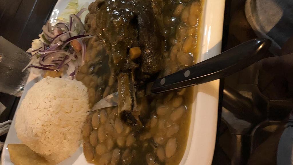 Seco De Cordero · Lamb shank, cilantro sauce, lima beans, white rice, fried cassava, criolla salad.