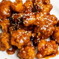 Sesame Chicken · Served with chicken wing spring roll and fried rice.