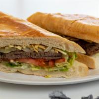 Pan Con Bistec (Steak Sandwich) · Palomilla steak with sauteed onions, lettuce, tomatoes and potato stixs on a soft cuban bread.