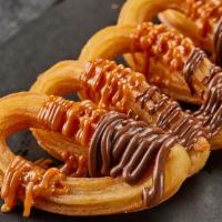 Churros · Crispy churros with Nutella and Dulce de leche.