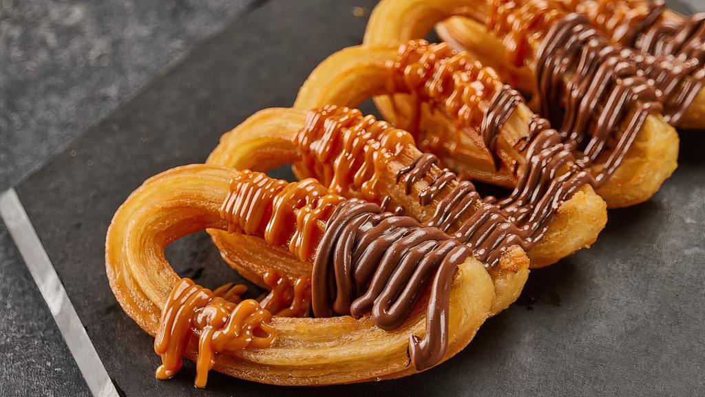 Churros · Crispy churros with Nutella and Dulce de leche.