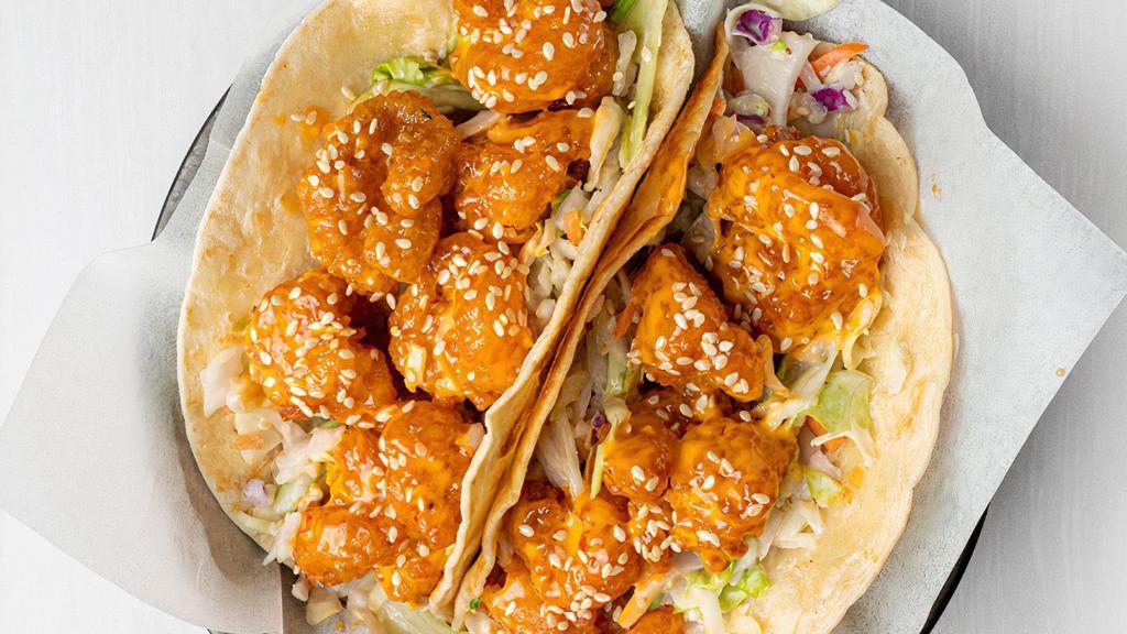Firecracker Shrimp Taco · Our famously fried shrimp is tossed in sweet'n'spicy firecracker sauce over garlic ginger slaw in two flour tortillas, sprinkled with sesame seeds. Served with chips & salsa. (1450 cal.)