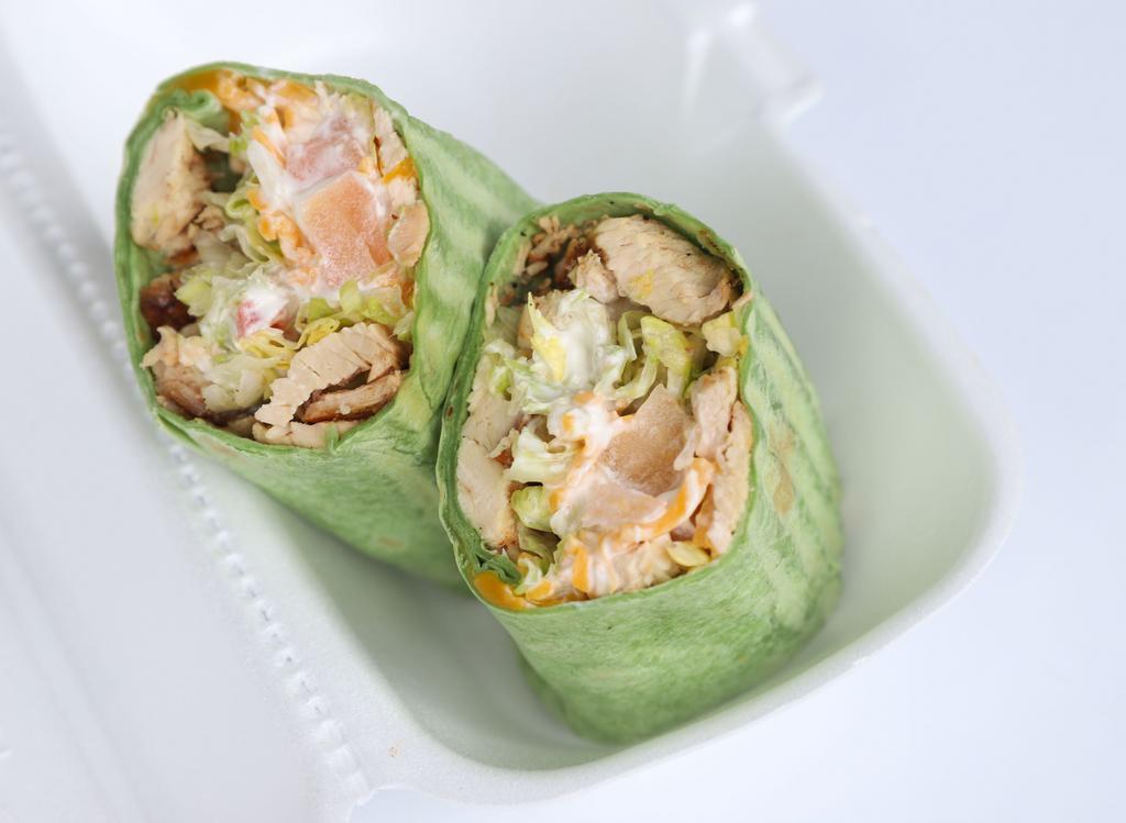 South Of The Border Wrap · Chopped grilled chicken breast, lettuce, tomatoes, cheese, sour cream, and guacamole.