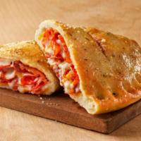 Pepperoni Stromboli · Made on our NYP dough. Pepperoni, mozzarella, and cheddar topped with garlic butter and magi...